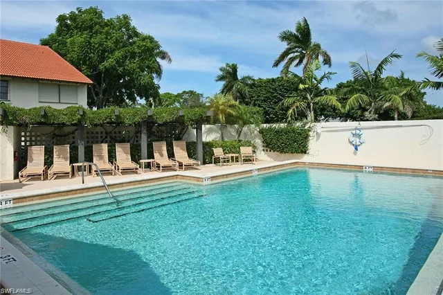 a swimming pool with outdoor seating and yard
