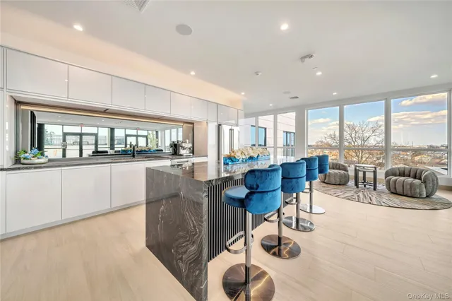 a living room with furniture and view of kitchen