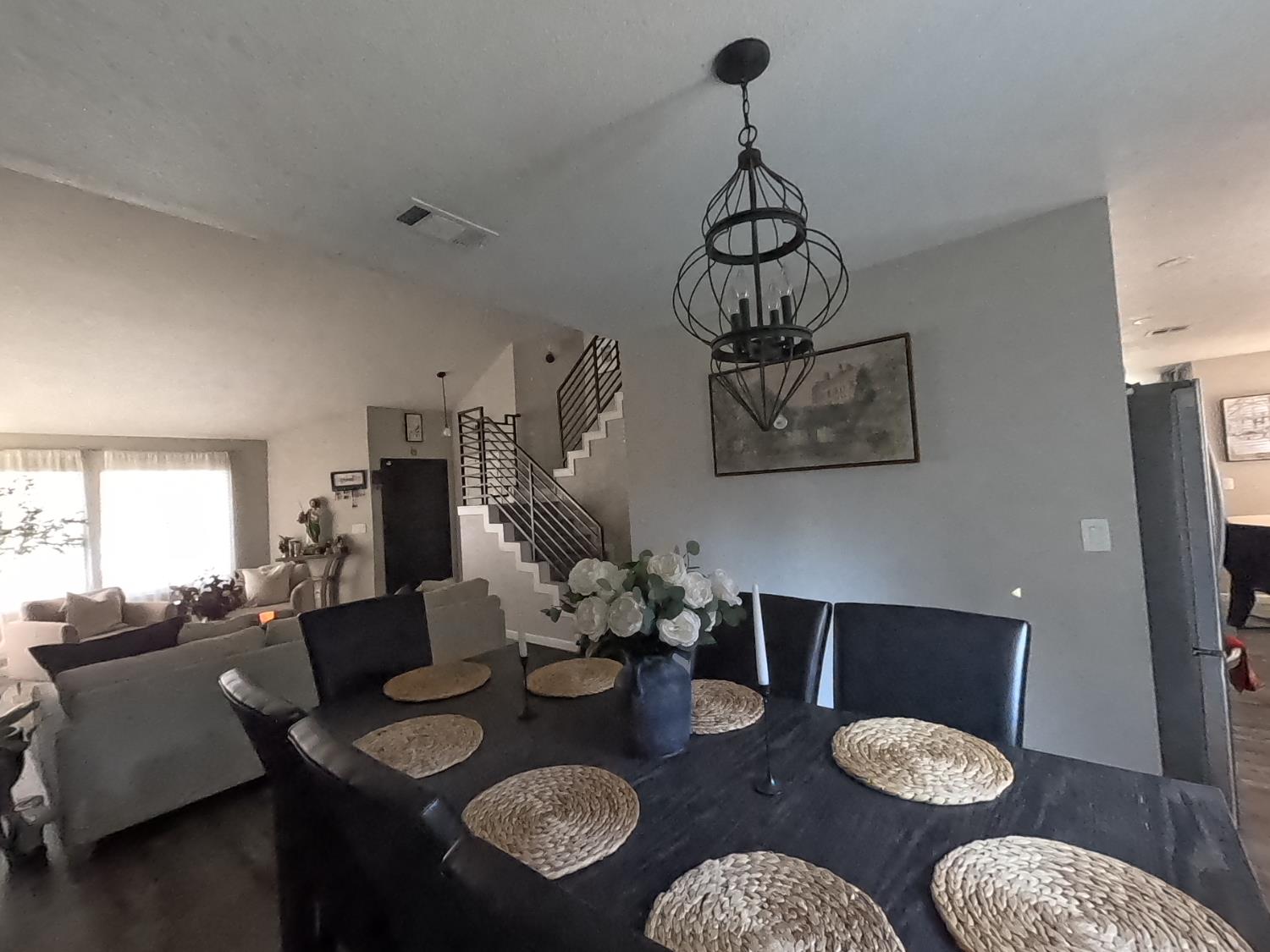 1920 Pontelli Court Stockton, CA 95207 - Photo 4 of 10 a view of a dining room with furniture a chandelier and wooden floor