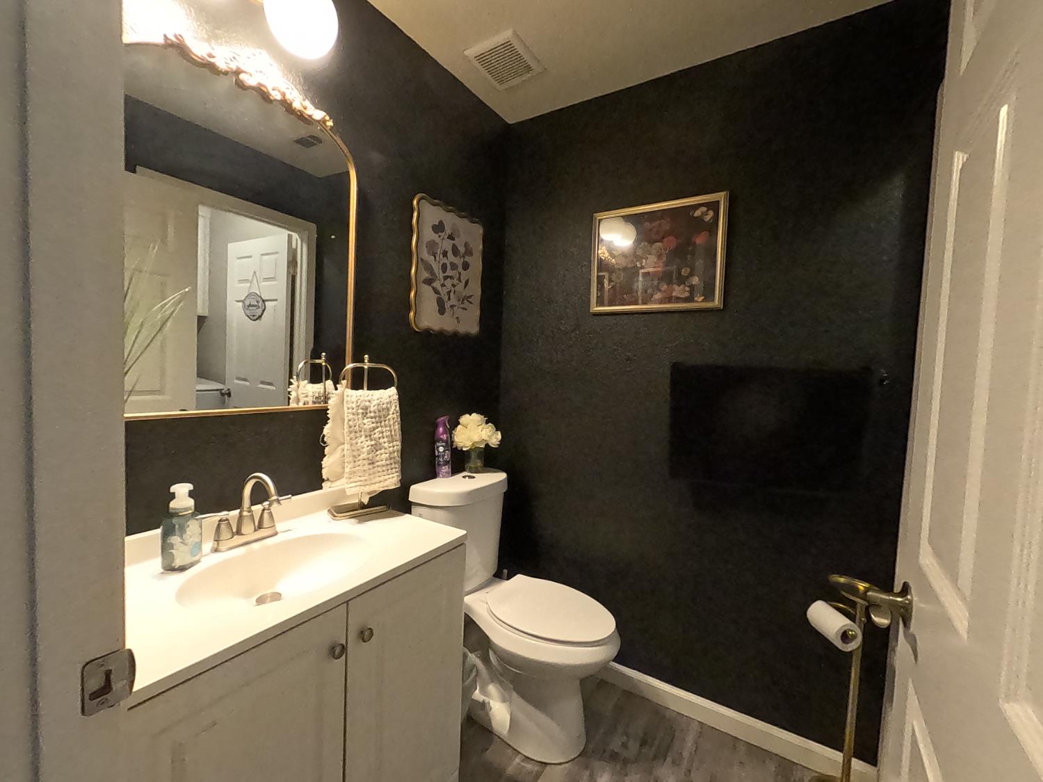 1920 Pontelli Court Stockton, CA 95207 - Photo 9 of 10 a bathroom with a toilet a sink and mirror