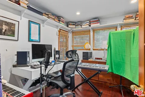 a work room with furniture and a flat screen tv