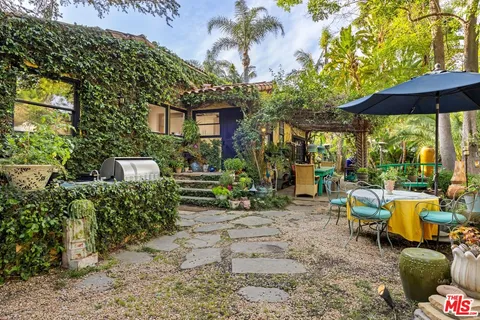 a view of a chairs and table in the patio