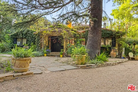 a view of a house with sitting area and garden
