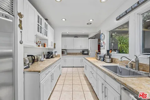 a large white kitchen with a lot of counter space
