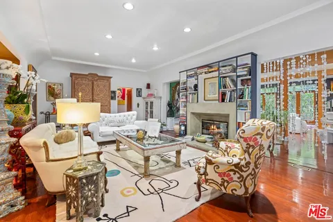 a living room with fireplace furniture and a wooden floor