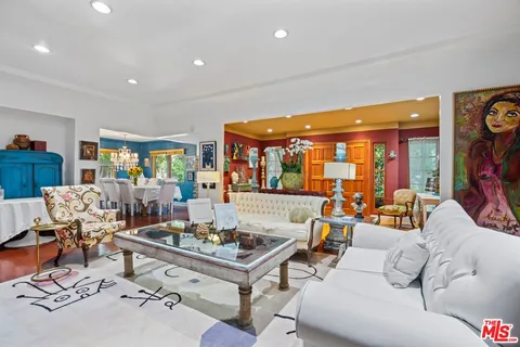 a living room with lots of furniture and view of kitchen