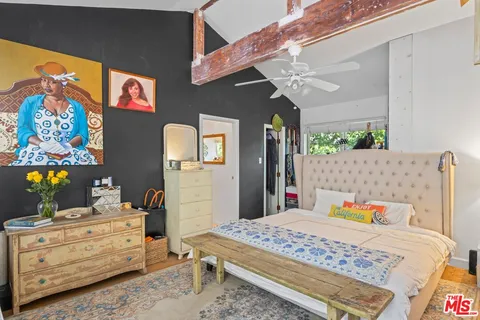 a bedroom with a bed and a dresser in it