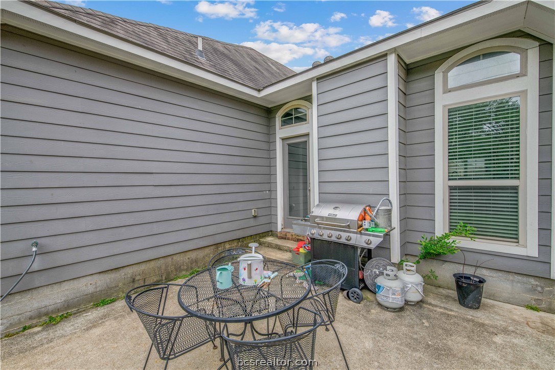 3014 Positano Loop Bryan, TX 77808 - Photo 20 of 23 a backyard of a house with table and chairs