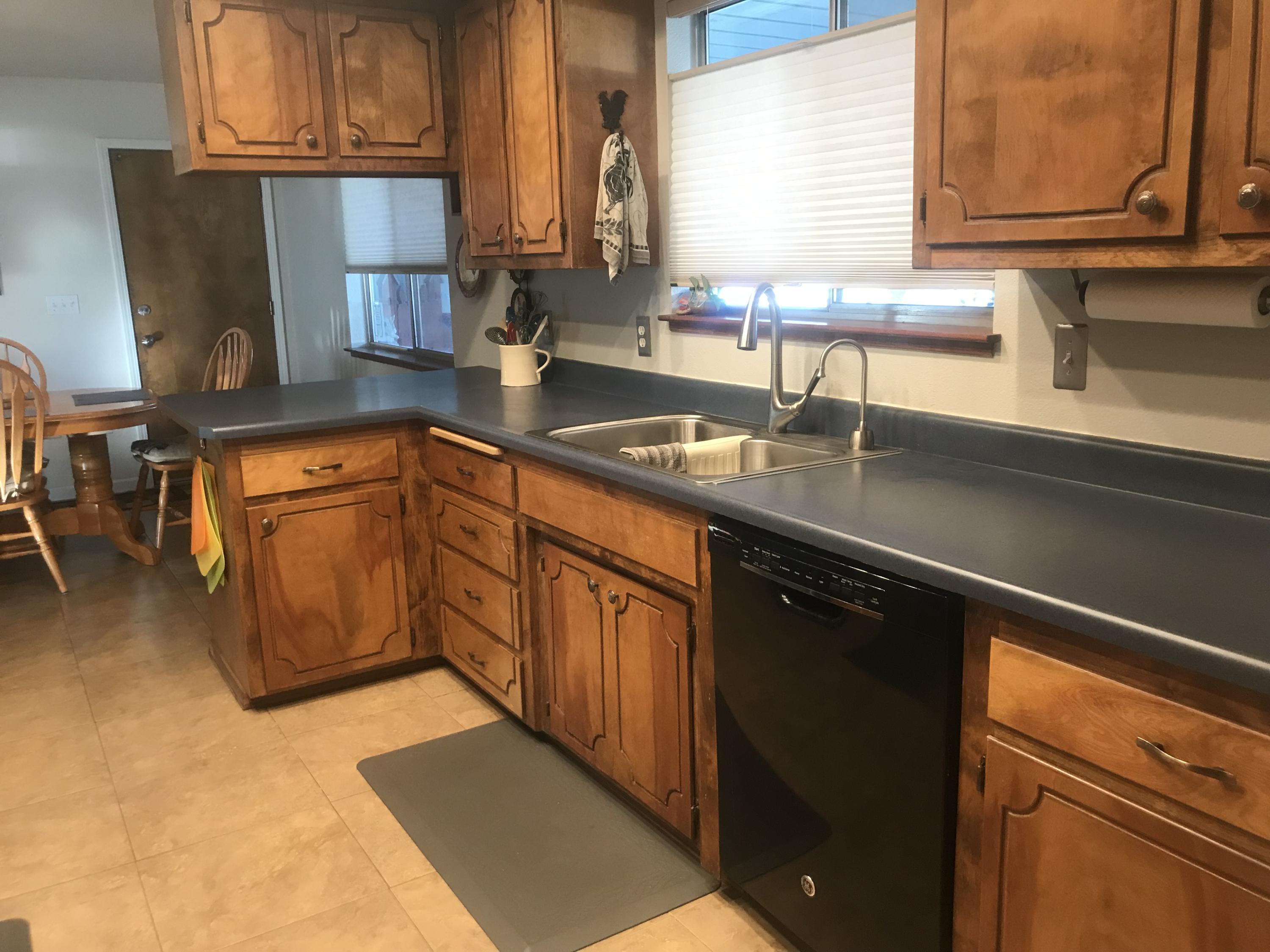 6730 Riverside Drive Redding, CA 96001 - Photo 2 of 23 a kitchen with stainless steel appliances granite countertop a sink stove and cabinets