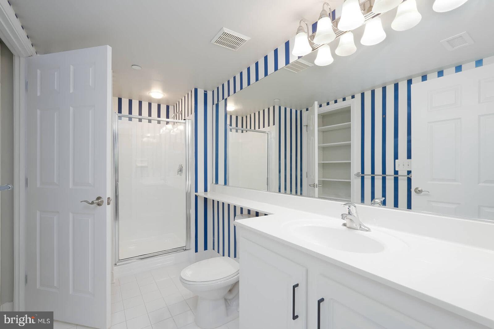 11710 Old Georgetown Road, Unit 429 North Bethesda, MD 20852 - Photo 11 of 40 a bathroom with a sink a toilet and a mirror