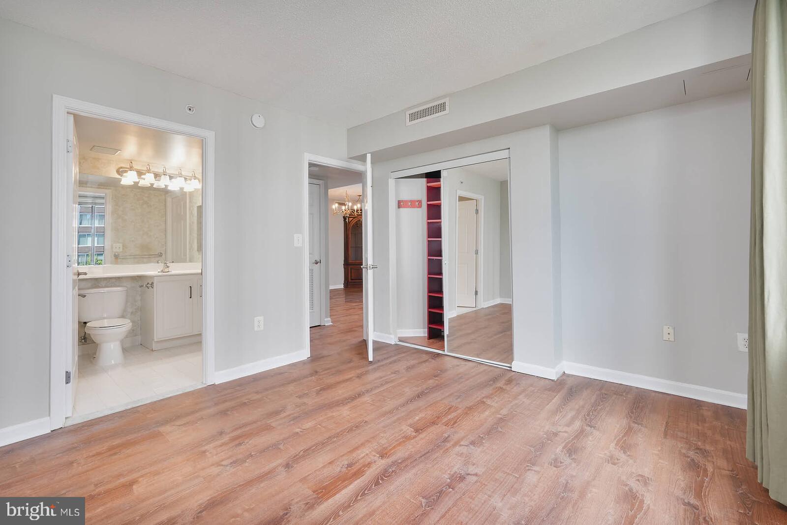 11710 Old Georgetown Road, Unit 429 North Bethesda, MD 20852 - Photo 13 of 40 wooden floor in an empty room and a bathroom