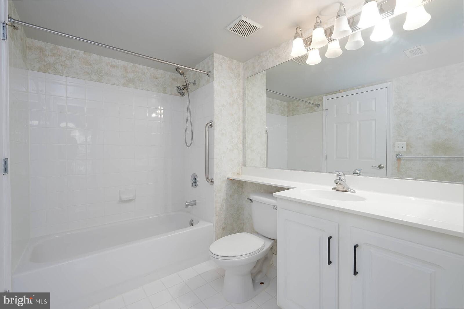 11710 Old Georgetown Road, Unit 429 North Bethesda, MD 20852 - Photo 14 of 40 a bathroom with a sink a toilet and shower
