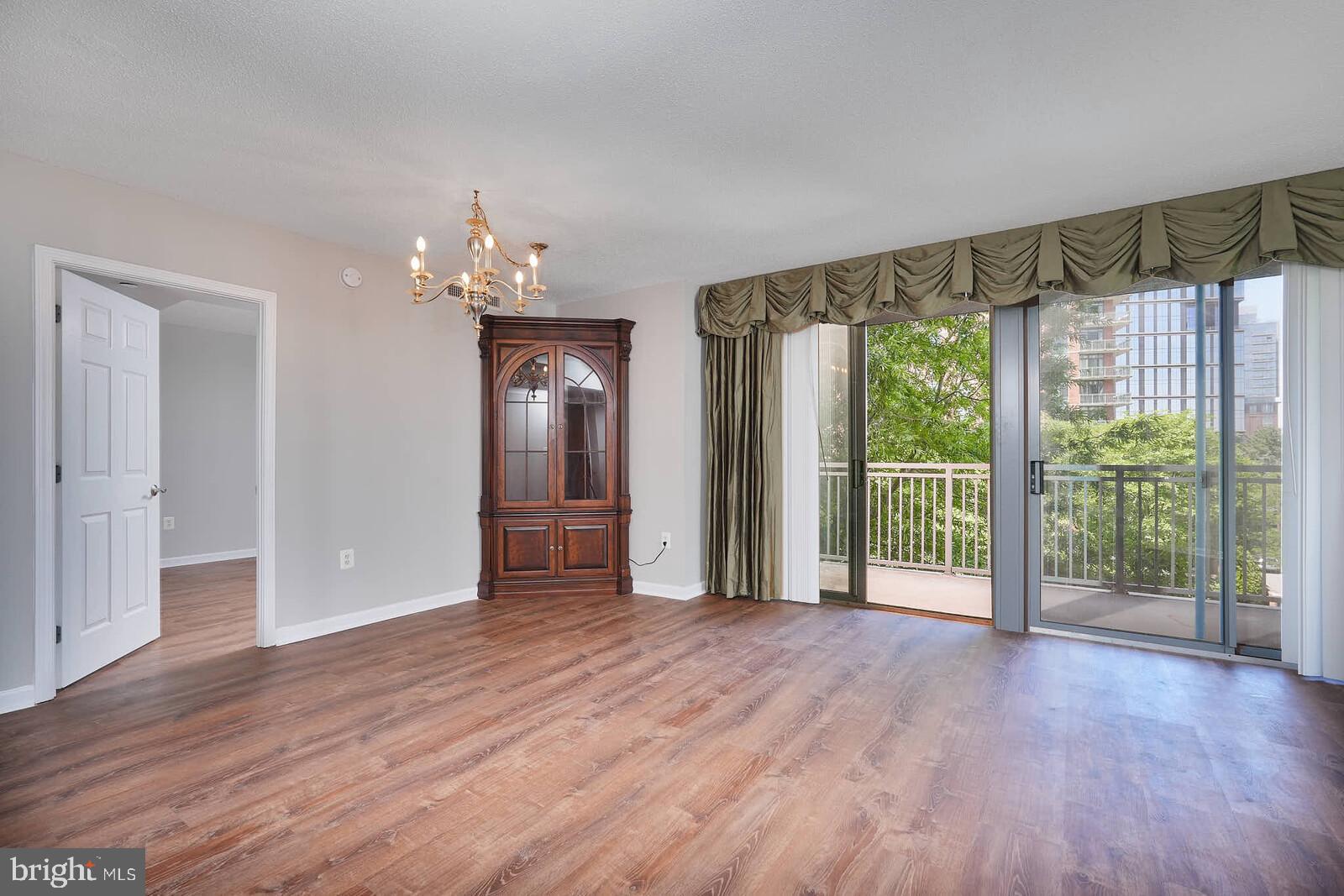 11710 Old Georgetown Road, Unit 429 North Bethesda, MD 20852 - Photo 15 of 40 a view of a big room with wooden floor and windows