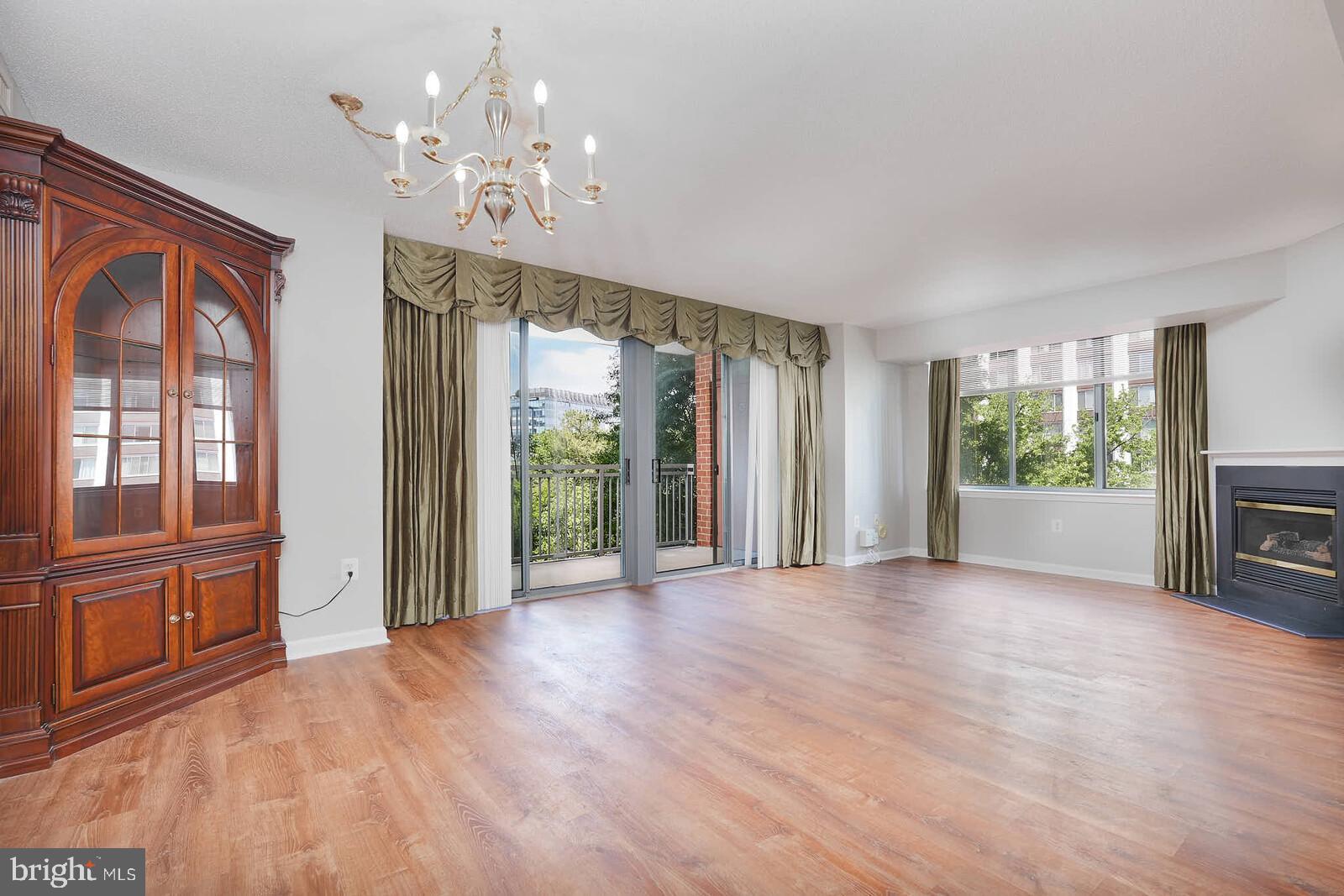 11710 Old Georgetown Road, Unit 429 North Bethesda, MD 20852 - Photo 6 of 40 a view of an empty room with a window and wooden floor