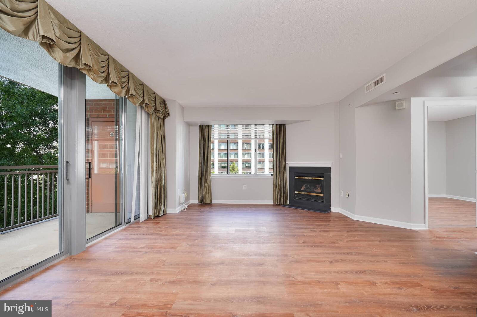 11710 Old Georgetown Road, Unit 429 North Bethesda, MD 20852 - Photo 7 of 40 a view of a big room with wooden floor fireplace and windows