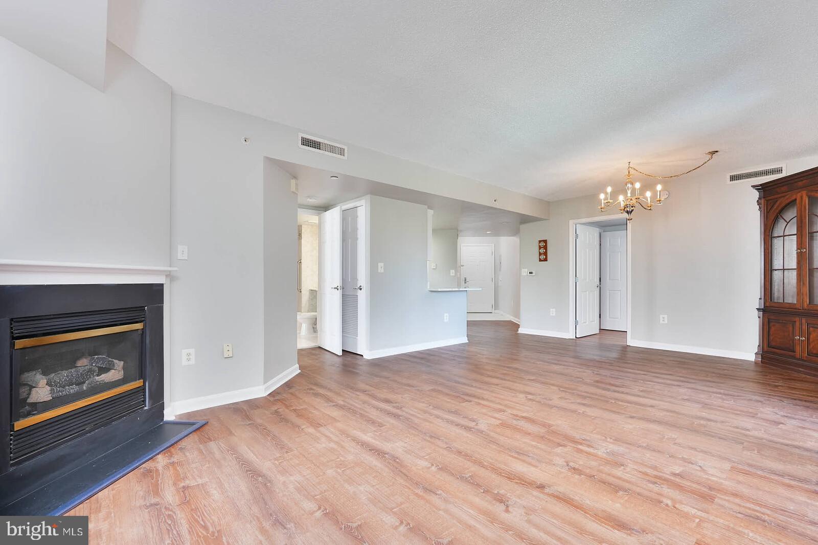 11710 Old Georgetown Road, Unit 429 North Bethesda, MD 20852 - Photo 8 of 40 a view of an empty room with a fireplace and a window