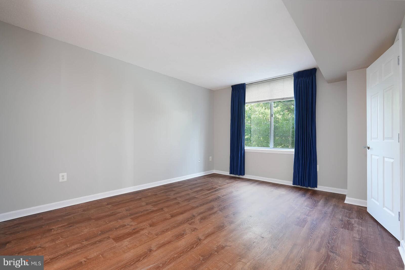 11710 Old Georgetown Road, Unit 429 North Bethesda, MD 20852 - Photo 9 of 40 a view of an empty room with wooden floor and a window