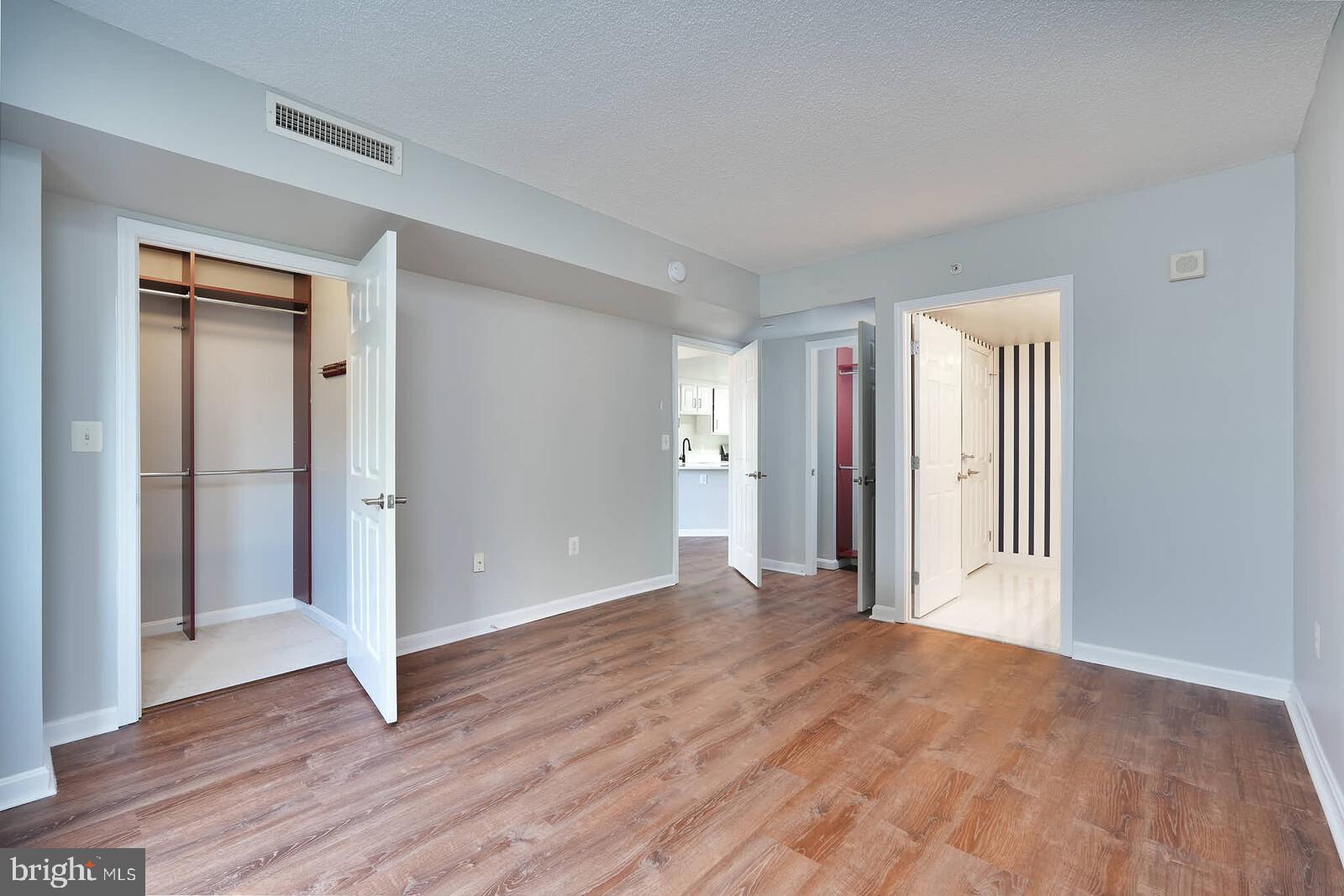 11710 Old Georgetown Road, Unit 429 North Bethesda, MD 20852 - Photo 10 of 40 a view of a livingroom with wooden floor and closet area