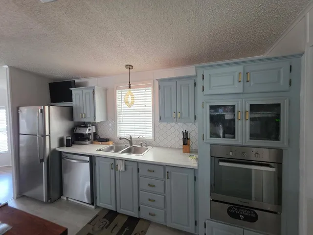 a kitchen with a sink appliances and cabinets