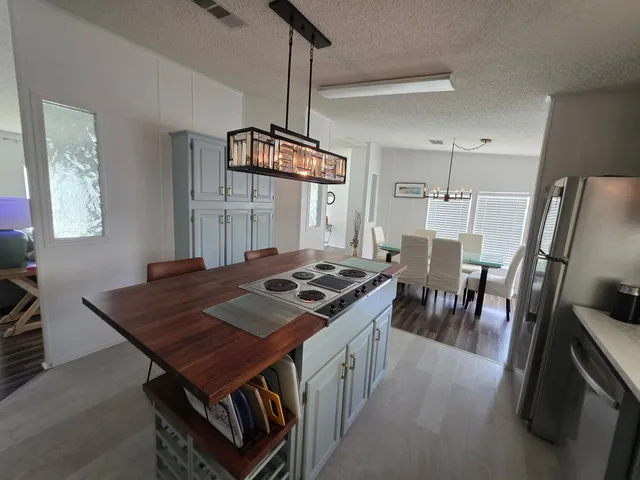 a kitchen with a stove a sink a dining table and chairs