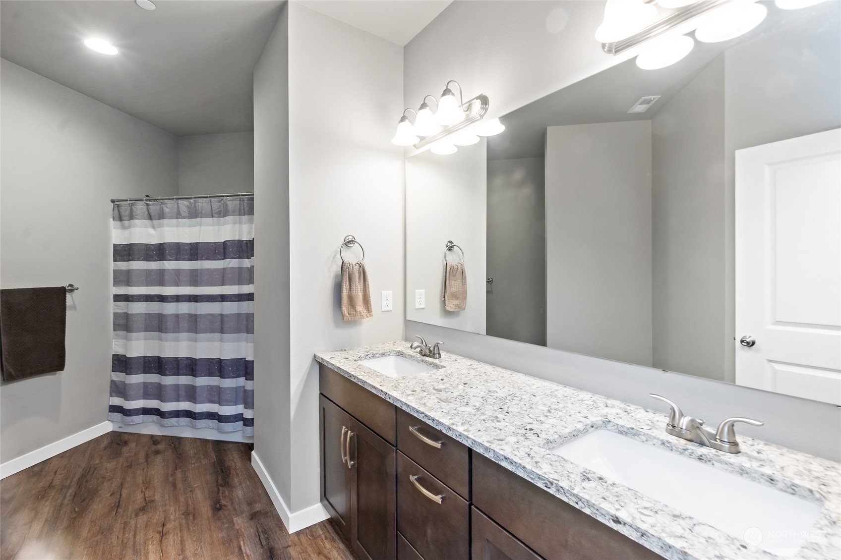 7101 Vandermark Road East Bonney Lake, WA 98391 - Photo 14 of 39 a bathroom with a granite countertop sink a large mirror and a shower