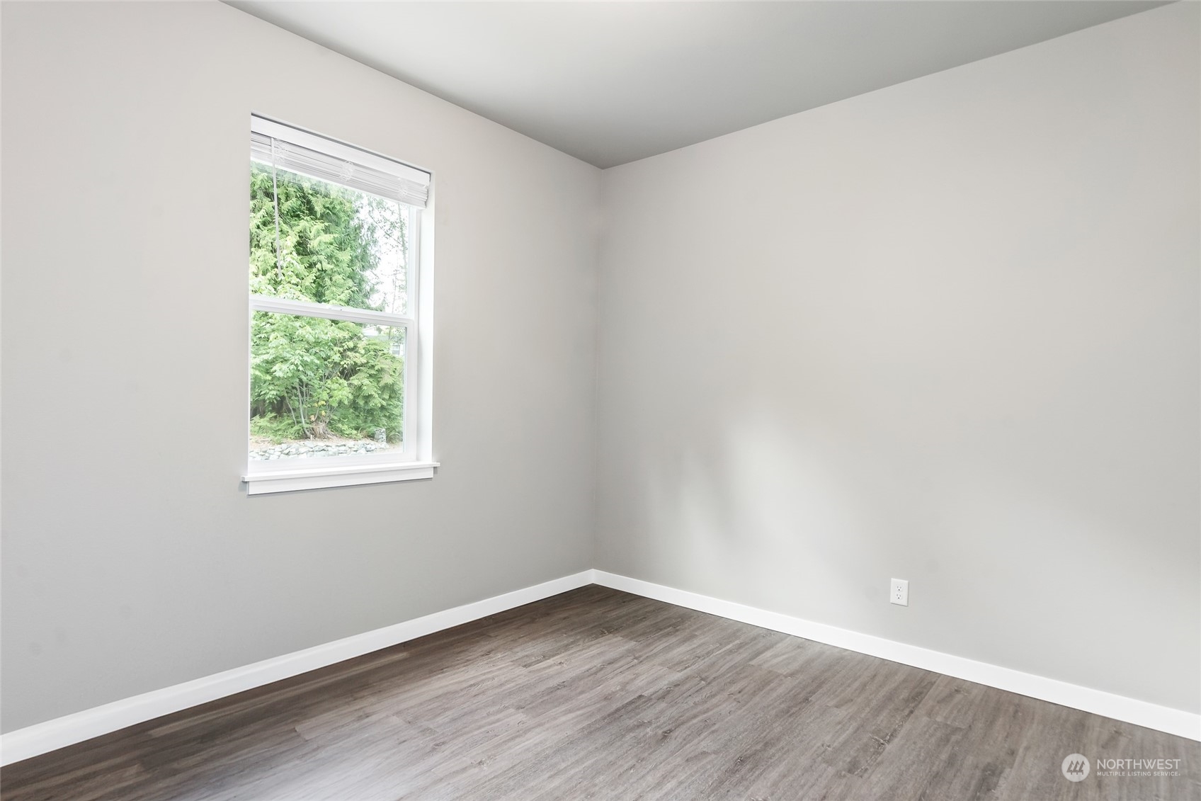 7101 Vandermark Road East Bonney Lake, WA 98391 - Photo 17 of 39 an empty room with wooden floor and windows