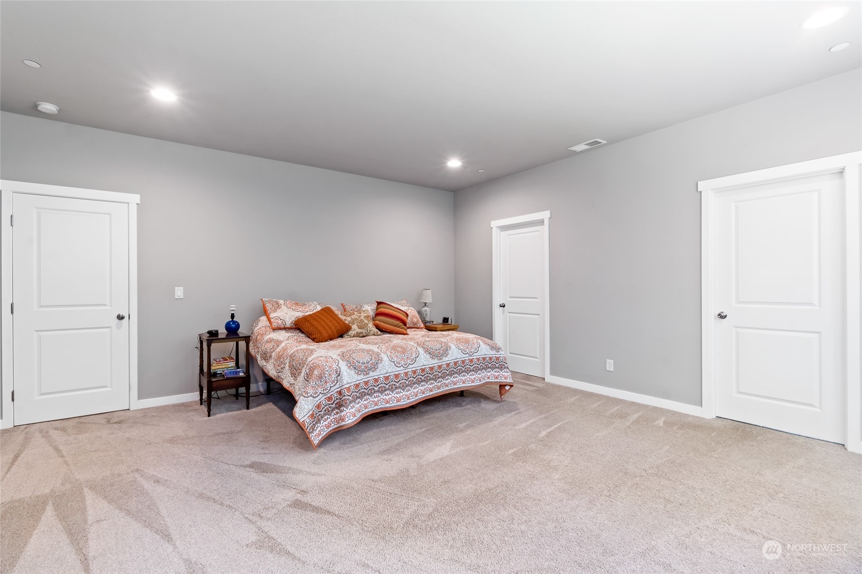 7101 Vandermark Road East Bonney Lake, WA 98391 - Photo 20 of 39 a spacious bedroom with a bed and a couch