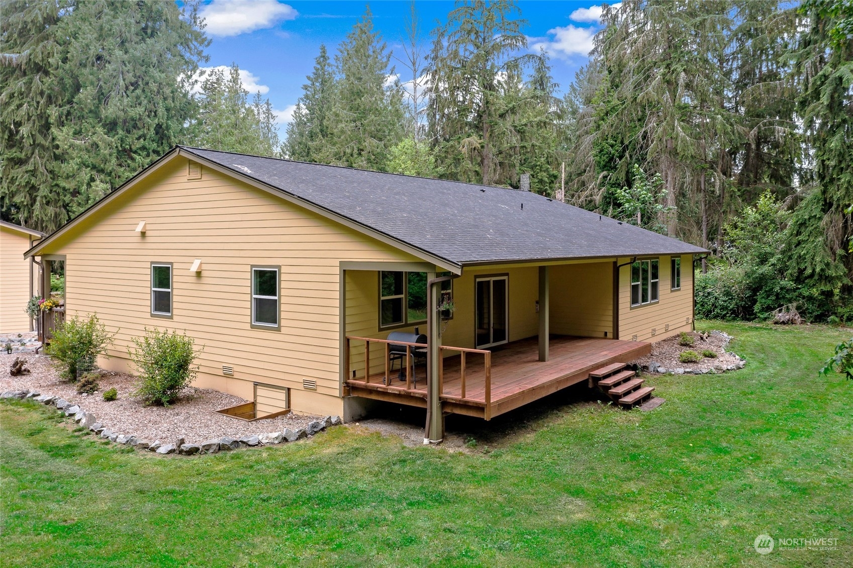 7101 Vandermark Road East Bonney Lake, WA 98391 - Photo 25 of 39 a view of a house with a yard chairs and a yard