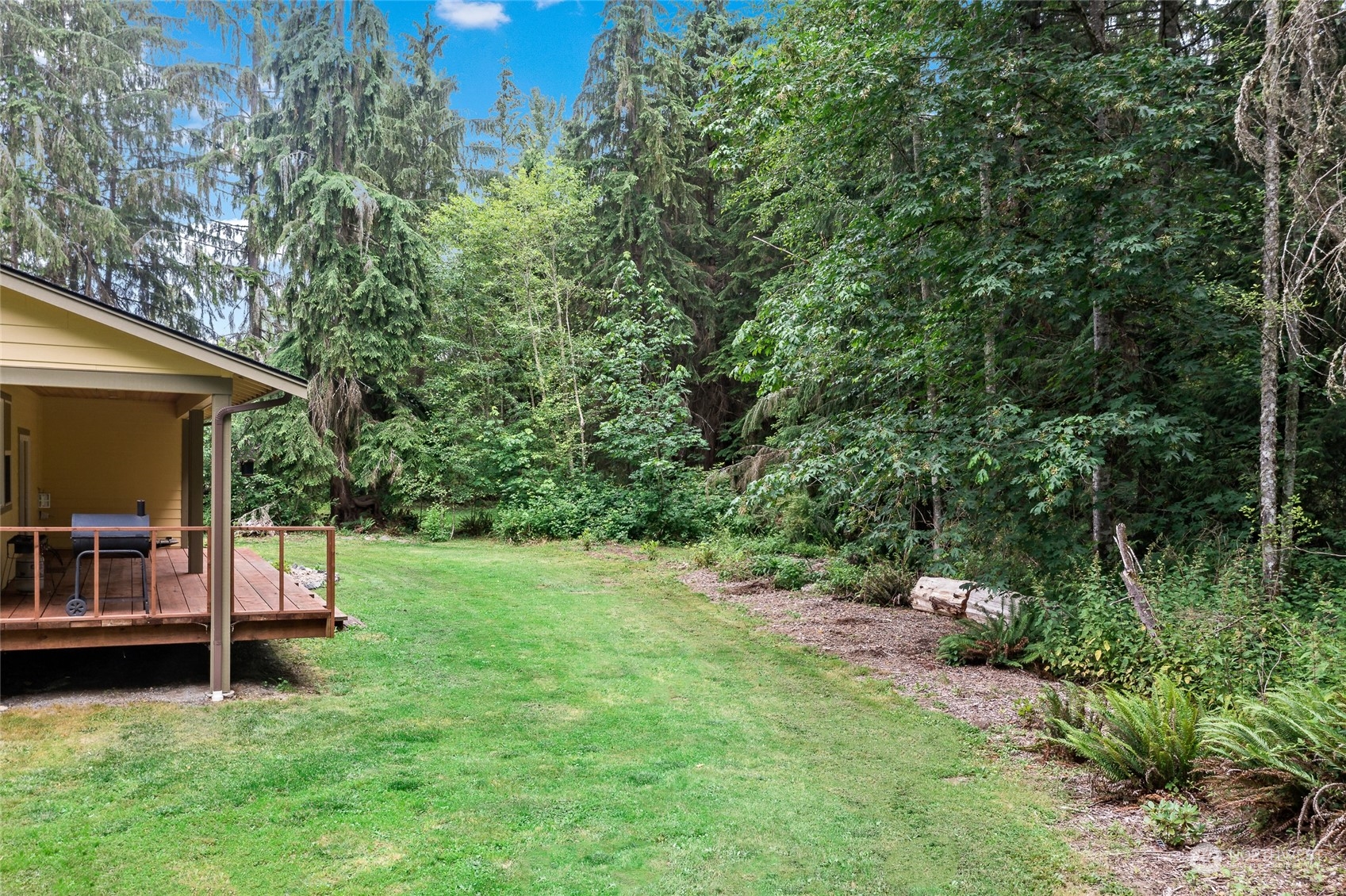 7101 Vandermark Road East Bonney Lake, WA 98391 - Photo 27 of 39 a backyard of a house with table and chairs