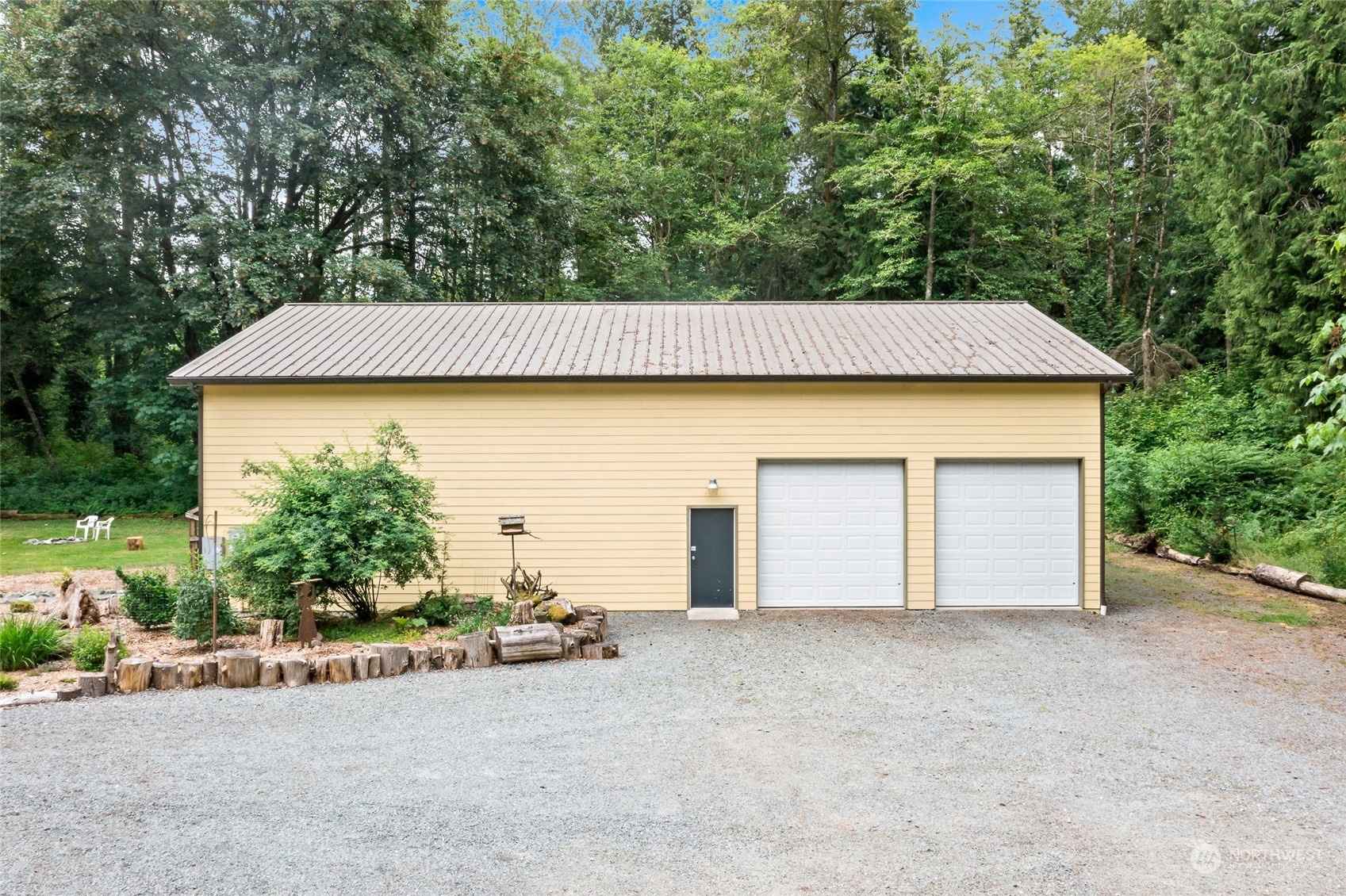 7101 Vandermark Road East Bonney Lake, WA 98391 - Photo 28 of 39 a front view of a house with a garden and garage