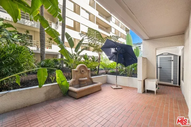 a wooden bench sitting in front of a building