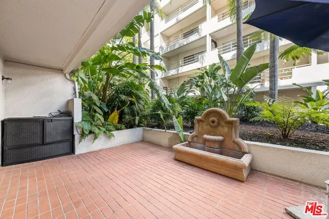 a kitchen with stainless steel appliances granite countertop a sink and a stove top oven