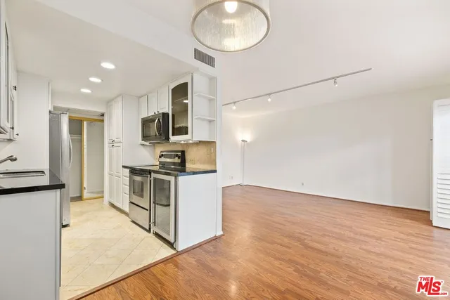 a kitchen with a refrigerator and a sink