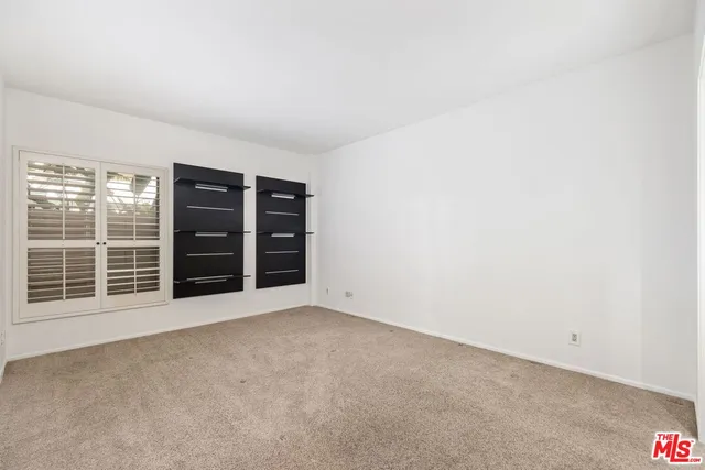 a bathroom with a sink a toilet a mirror and shower