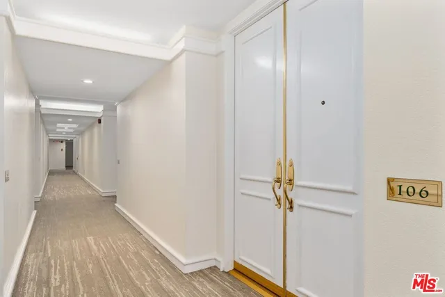 a view of an empty room with closet and a window