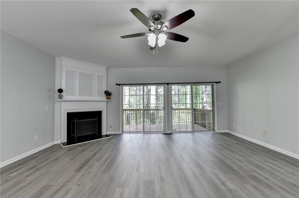 3977 Howell Park Road Duluth, GA 30096 - Photo 9 of 25 a view of an empty room with wooden floor and a fireplace