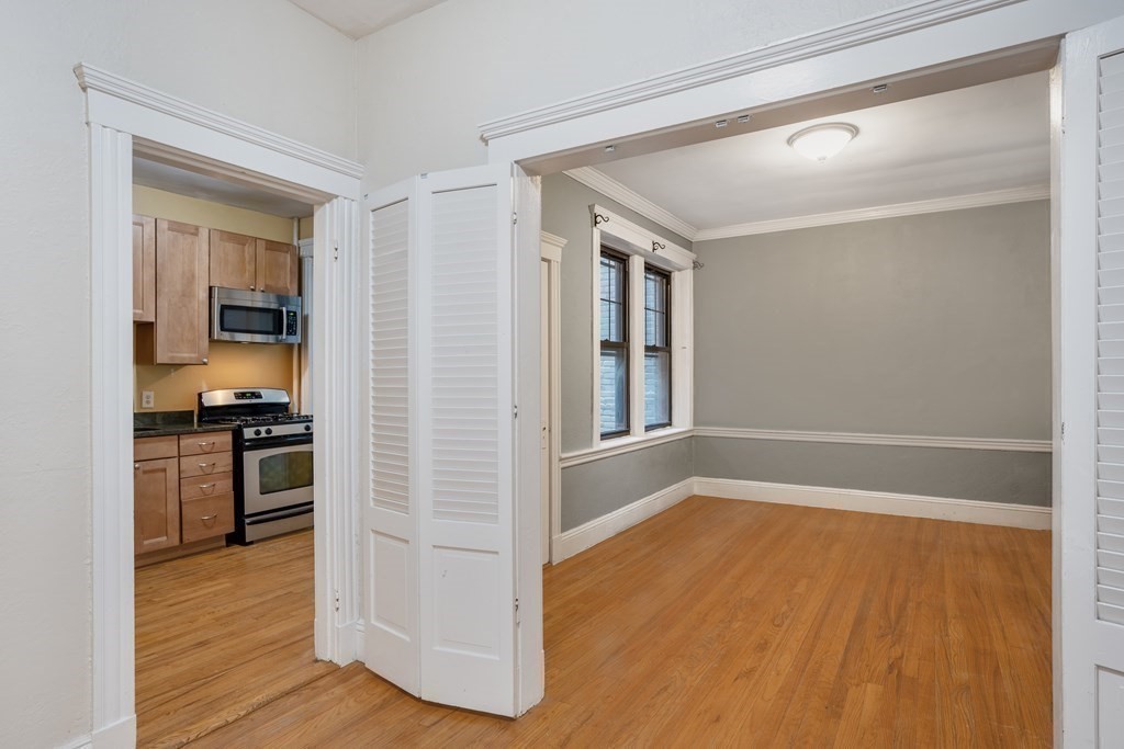 59 Lanark Road, Unit 2 Boston, MA 02135 - Photo 5 of 18 a view of a kitchen cabinets and wooden floor