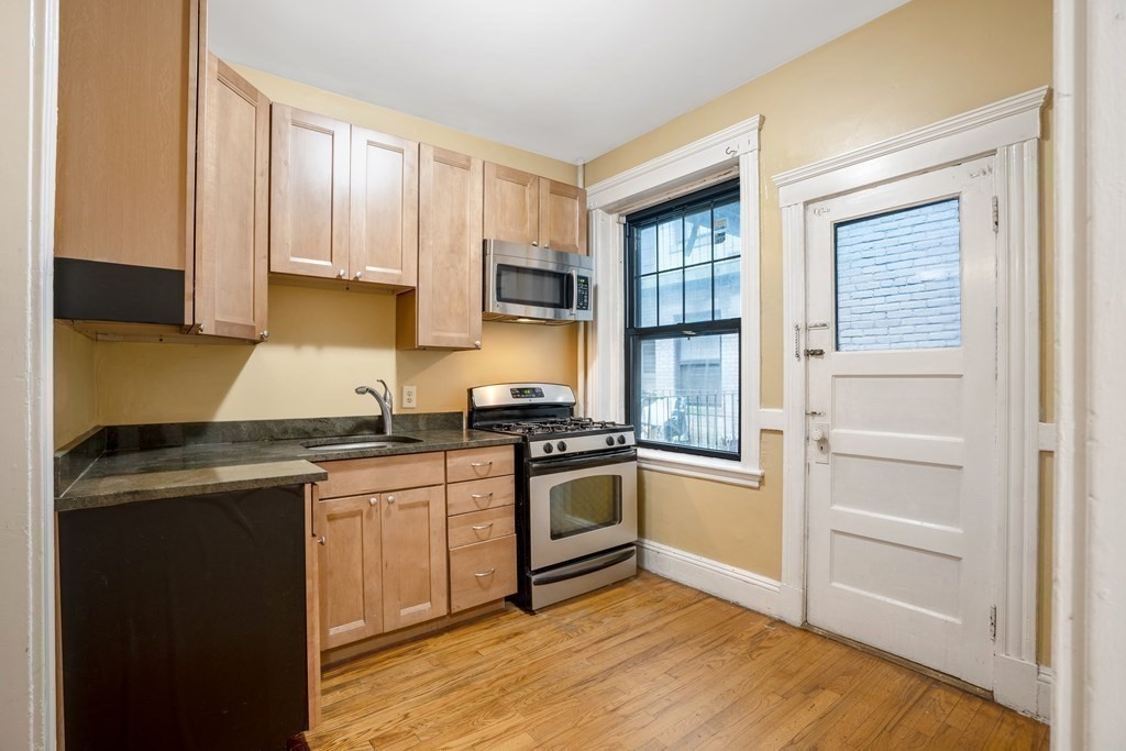 59 Lanark Road, Unit 2 Boston, MA 02135 - Photo 6 of 18 a kitchen with a stove top oven and sink