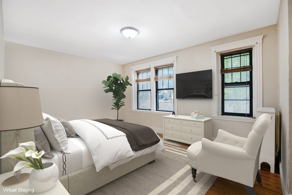 59 Lanark Road, Unit 2 Boston, MA 02135 - Photo 9 of 18 a spacious bedroom with a bed and a flat screen tv