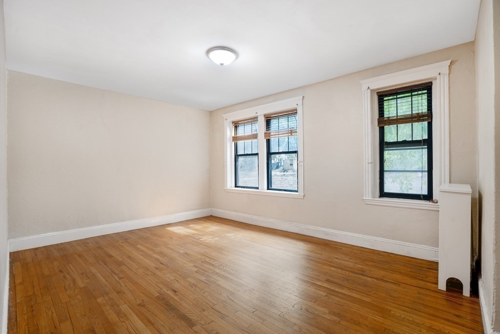 59 Lanark Road, Unit 2 Boston, MA 02135 - Photo 10 of 18 a view of an empty room with wooden floor and a window