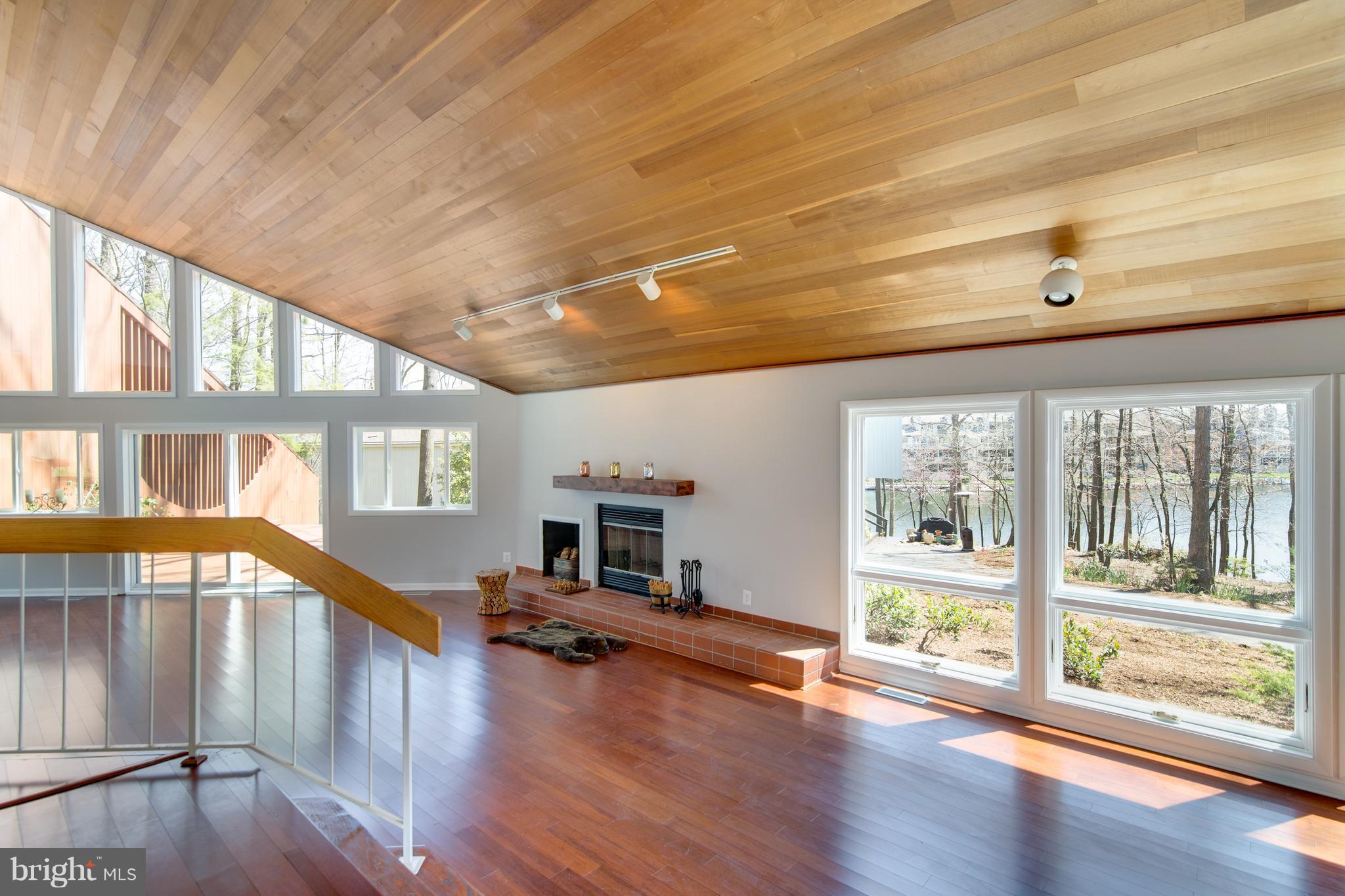 Living room is so open with wood ceiling!