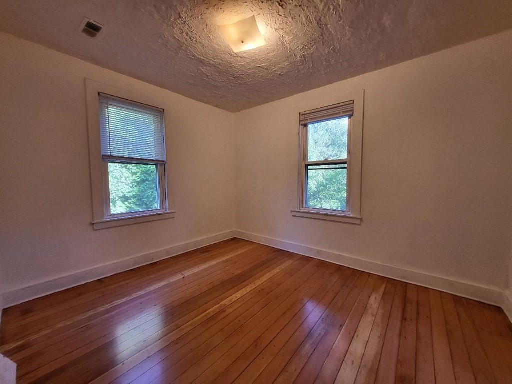 69 Stafford Road Holland, MA 01521 - Photo 11 of 27 a view of an empty room with wooden floor and a window