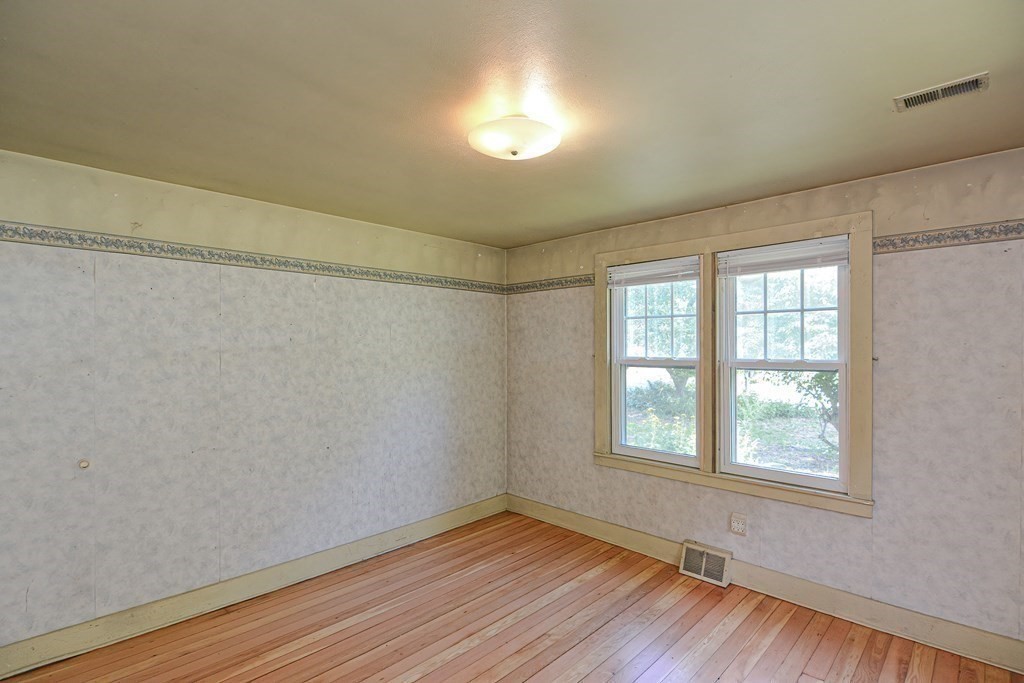 69 Stafford Road Holland, MA 01521 - Photo 12 of 27 a view of an empty room with wooden floor and a window