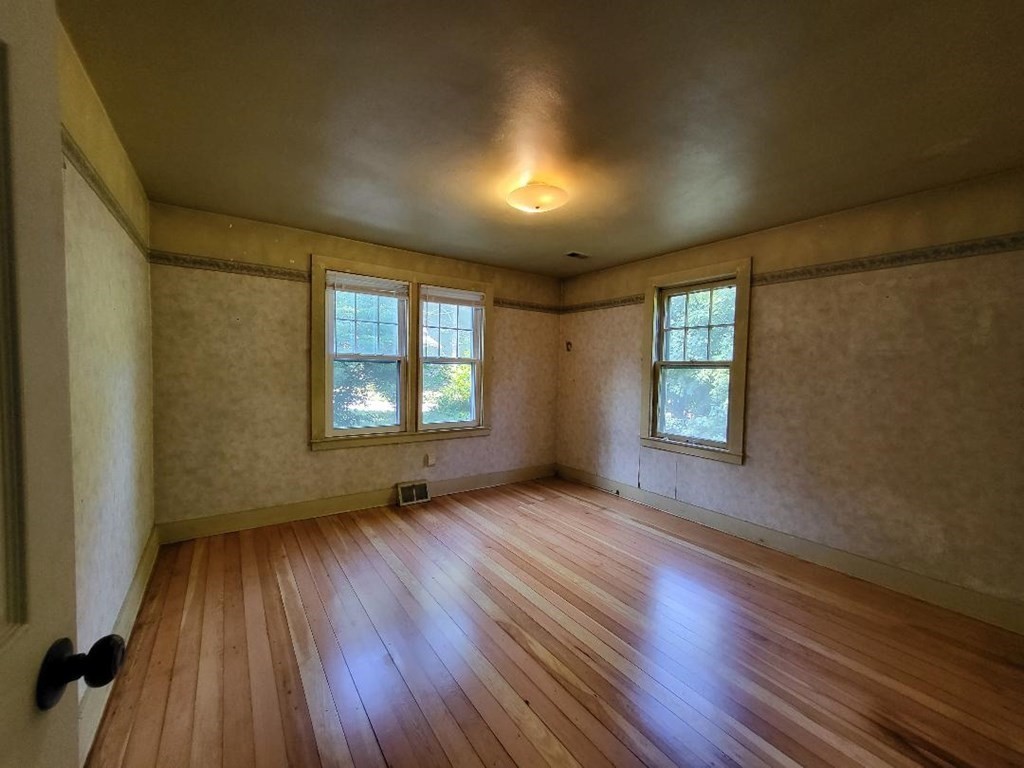 69 Stafford Road Holland, MA 01521 - Photo 13 of 27 an empty room with wooden floor and windows
