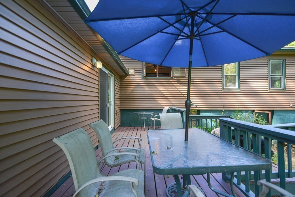 69 Stafford Road Holland, MA 01521 - Photo 21 of 27 a view of a patio with a table and chairs under an umbrella