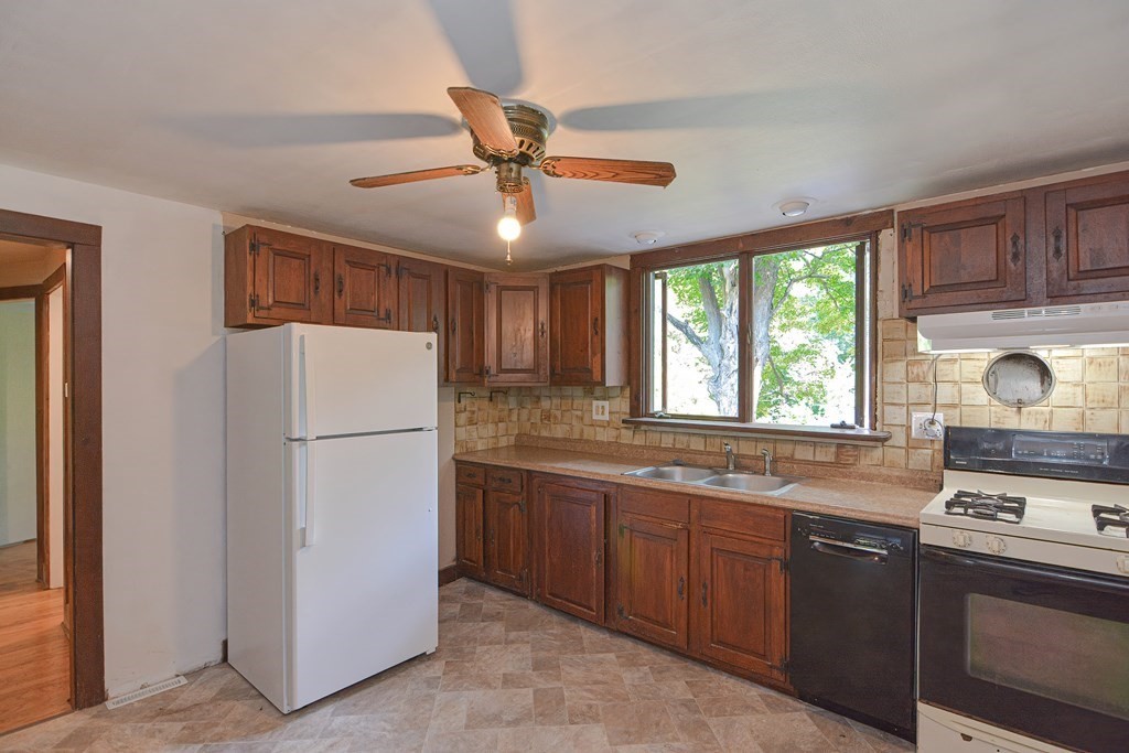 69 Stafford Road Holland, MA 01521 - Photo 3 of 27 a kitchen with stainless steel appliances granite countertop a refrigerator and a sink