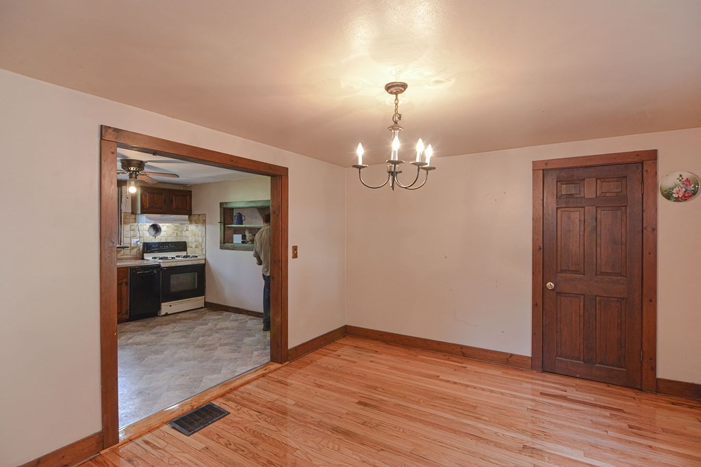 69 Stafford Road Holland, MA 01521 - Photo 4 of 27 a view of a room with a chandelier and wooden floor