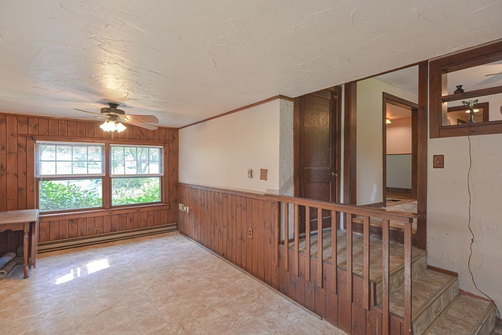 69 Stafford Road Holland, MA 01521 - Photo 9 of 27 an empty room with windows and chandelier fan