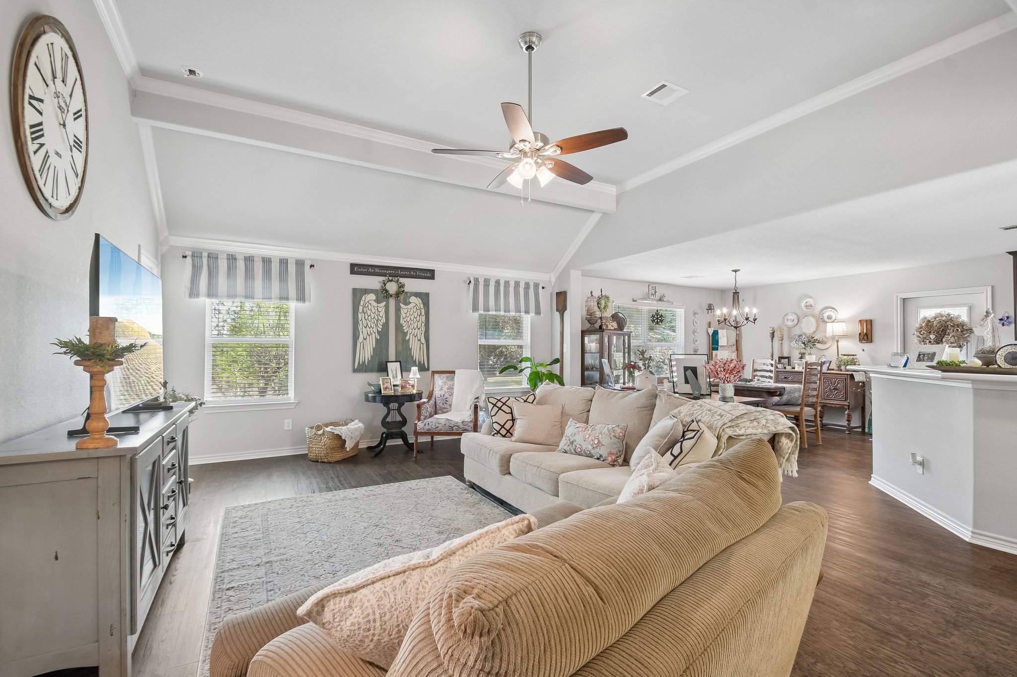 596 Pleasant Grove Loop Elgin, TX 78621 - Photo 7 of 37 Vaulted ceilings and rich wood floors anchor this inviting, open-concept living space.