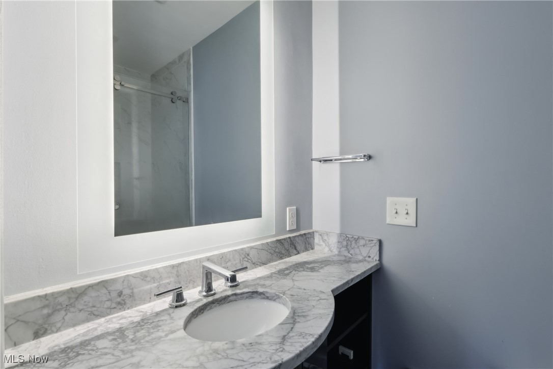 800 Merriman Road Akron, OH 44303 - Photo 25 of 42 Bathroom featuring vanity and a shower